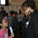 Country Financial Area Rep, Kandi Keyes-Winford being interviewed by a Ray Elementary 3rd Grader as part of the Money Press Conference.